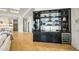 Modern wet bar with glass shelving and wine refrigerator at 4880 E Lone Mountain N Rd, Cave Creek, AZ 85331