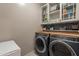 Well-appointed laundry room with washer, dryer, and ample storage at 27245 N 178Th Ave, Surprise, AZ 85387