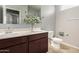 Well-lit bathroom with double vanity and toilet at 3660 N 310Th Ln, Buckeye, AZ 85396