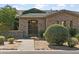 Stone facade home with a wooden gate and manicured landscaping at 7377 E Alta Sierra Dr, Scottsdale, AZ 85266