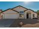 Single-story house with a two-car garage and desert landscaping at 10363 W Willow Ln, Avondale, AZ 85392