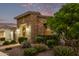 Landscaped yard with a stone exterior home at 10553 E Relativity Ave, Mesa, AZ 85212