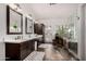 Elegant bathroom featuring double sinks and a soaking tub at 1201 E Le Marche Ave, Phoenix, AZ 85022