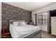 Comfortable bedroom featuring a queen bed and brick accent wall at 1201 E Le Marche Ave, Phoenix, AZ 85022