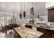 Island kitchen with granite countertops and pendant lighting at 1201 E Le Marche Ave, Phoenix, AZ 85022