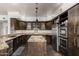 Spacious kitchen with granite countertops, stainless steel appliances, and dark wood cabinetry at 1201 E Le Marche Ave, Phoenix, AZ 85022