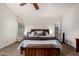 Bright main bedroom featuring a king bed and two windows at 1201 E Le Marche Ave, Phoenix, AZ 85022