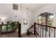 Upper hallway with a view, wood railing, and a large window at 1201 E Le Marche Ave, Phoenix, AZ 85022