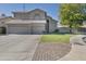 Two-story house with a landscaped yard and two-car garage at 22208 N 34Th Ln, Phoenix, AZ 85027