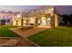 Spacious backyard patio with fire pit and string lights, perfect for outdoor entertaining at 2346 E Sanoque Ct, Gilbert, AZ 85298