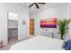 Bedroom with large art piece, walk-in closet, and ceiling fan at 2346 E Sanoque Ct, Gilbert, AZ 85298