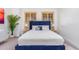 Bedroom with blue velvet headboard bed, wood shutters, and ceiling fan at 2346 E Sanoque Ct, Gilbert, AZ 85298