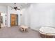 Spacious bedroom with ceiling fan, closet, and sitting area at 2346 E Sanoque Ct, Gilbert, AZ 85298