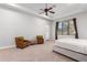 Bright bedroom with a queen bed, seating area, and access to backyard at 2346 E Sanoque Ct, Gilbert, AZ 85298