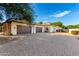 Three-car garage with dark brown doors and stone accents at 2346 E Sanoque Ct, Gilbert, AZ 85298