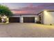 Three-car garage with dark brown doors and lighting at 2346 E Sanoque Ct, Gilbert, AZ 85298