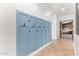 Hallway with blue coat hooks and view into main bedroom at 2346 E Sanoque Ct, Gilbert, AZ 85298