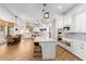 Open concept kitchen with island, stainless steel appliances, and dining area at 2346 E Sanoque Ct, Gilbert, AZ 85298