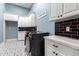 Laundry room with white cabinets and patterned tile floor at 2346 E Sanoque Ct, Gilbert, AZ 85298