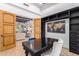Home office with built-in shelving, world map art, and desk at 2346 E Sanoque Ct, Gilbert, AZ 85298