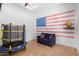 Playroom with mini trampoline and American flag wall at 2346 E Sanoque Ct, Gilbert, AZ 85298