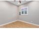Simple spare bedroom with wood floors and window shutters at 2346 E Sanoque Ct, Gilbert, AZ 85298