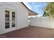 Backyard patio with white brick walls, French doors, and a wooden fence at 4008 N 32Nd Pl, Phoenix, AZ 85018