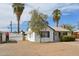 Charming white brick house with black trim, palm trees, and a gravel driveway at 4008 N 32Nd Pl, Phoenix, AZ 85018