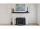 Close-up view of the living room's white fireplace with a decorative mantel and screen at 4008 N 32Nd Pl, Phoenix, AZ 85018