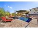 Inviting pool area with lounge chairs and umbrella for shade at 412 E Yearling Rd, Phoenix, AZ 85085