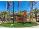 Stone entryway to the community featuring landscaping and flagpoles at 6202 E Mckellips Rd # 141, Mesa, AZ 85215