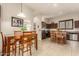 Open concept kitchen and breakfast nook with island and wood table at 6202 E Mckellips Rd # 141, Mesa, AZ 85215