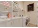 Laundry room with washer, dryer, and ample shelving at 6202 E Mckellips Rd # 141, Mesa, AZ 85215