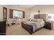 Spacious bedroom with large bed, carpeted floors, and a work space at 6202 E Mckellips Rd # 141, Mesa, AZ 85215
