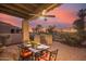 Outdoor patio with seating area, built-in grill, and sunset view at 6202 E Mckellips Rd # 141, Mesa, AZ 85215