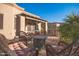 Spacious patio with fire pit, wicker furniture, and partial view of the house at 6202 E Mckellips Rd # 141, Mesa, AZ 85215