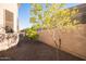 Small side yard with two small trees and gravel ground cover at 6202 E Mckellips Rd # 141, Mesa, AZ 85215
