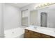 Bathroom with a double vanity, soaking tub and window at 3473 E Bruce Ave, Gilbert, AZ 85234
