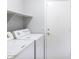 Laundry room with washer, dryer, and built-in shelving at 3473 E Bruce Ave, Gilbert, AZ 85234