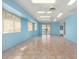 Sunroom with tile floor, light blue walls and multiple windows at 13247 W Bellwood Dr, Sun City West, AZ 85375