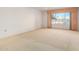 Bright living room featuring neutral carpeting and large window at 13247 W Bellwood Dr, Sun City West, AZ 85375