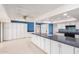 Bright kitchen features ample cabinetry, granite countertops, and a view to the patio at 13247 W Bellwood Dr, Sun City West, AZ 85375