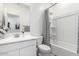 Clean bathroom with white vanity, bathtub, and shower at 18055 W Elm St, Goodyear, AZ 85395