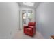 Relaxing sitting area with a red recliner and access to the backyard at 8140 N 107Th Ave # 129, Peoria, AZ 85345
