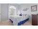 Cozy bedroom with a queen-size bed and arched window at 8140 N 107Th Ave # 129, Peoria, AZ 85345