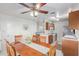 Bright dining area with wooden table and chairs, overlooking the kitchen at 8140 N 107Th Ave # 129, Peoria, AZ 85345