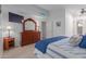 Comfortable bedroom with a dresser and large TV at 8140 N 107Th Ave # 129, Peoria, AZ 85345