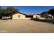 Back exterior view of single-story home with dirt driveway and RV at 7706 N 173Rd Ave, Waddell, AZ 85355