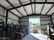 Workshop interior with open garage door and equipment storage at 7706 N 173Rd Ave, Waddell, AZ 85355