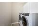 Bright laundry room with white washer and dryer at 9238 E Desert Park Dr, Scottsdale, AZ 85255